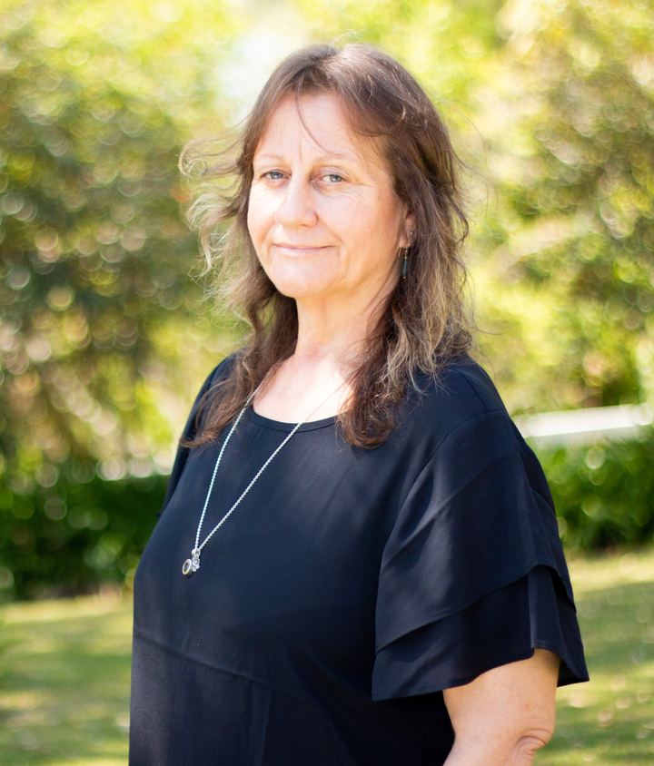 Tracy Barker standing in a sunlit garden