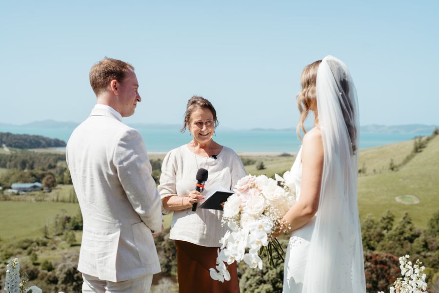 The groom listens as Tracy reads the ceremony beside the bride