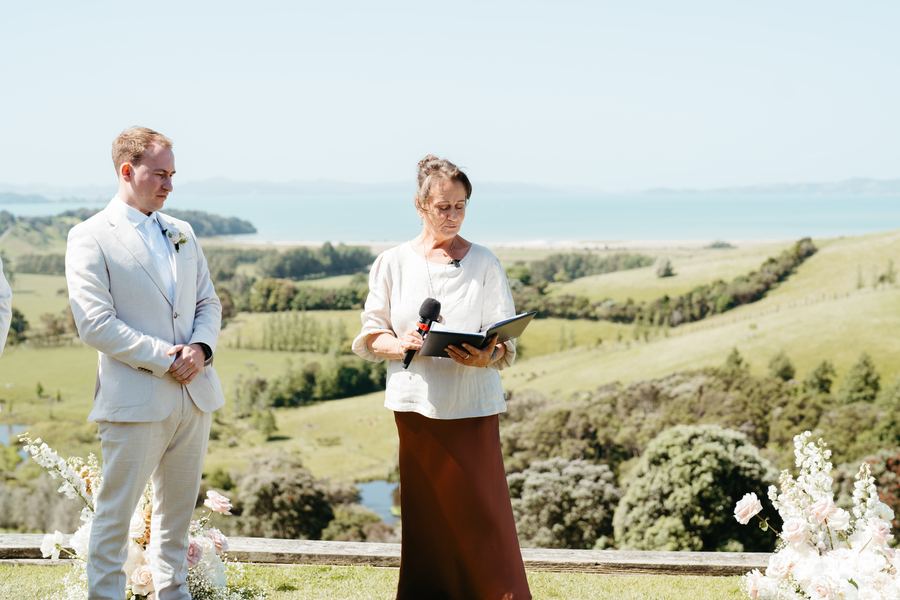 The groom and Tracy at the ceremony site overlooking rolling green hills