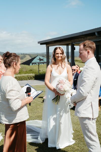Tracy reads to the couple beside a covered deck